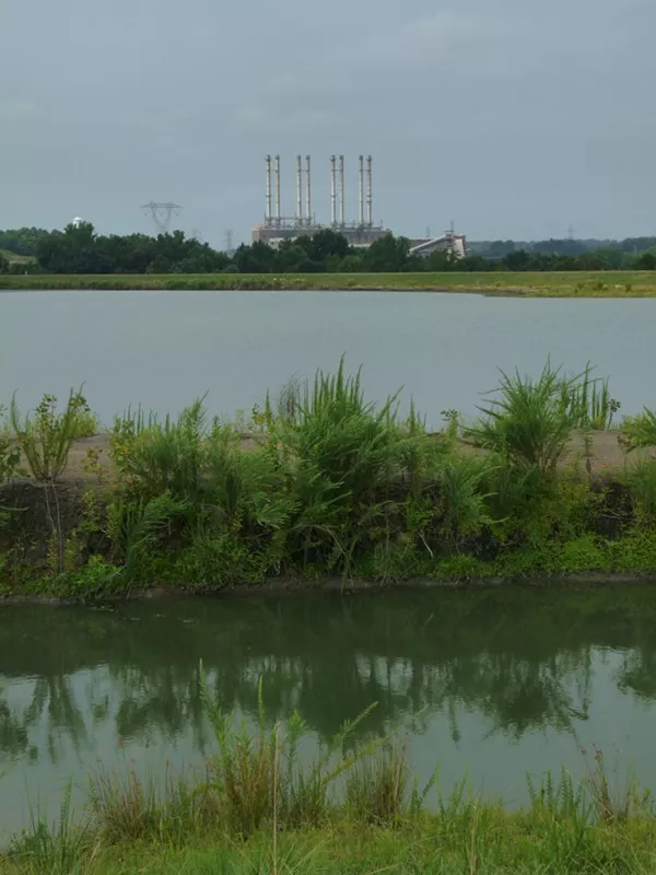 Looking across one of the two unlined, high-hazard coal ash ponds at Duke Energys Riverbend coal plant. The pond was built in 1957, covers over 40 surface acres and is 80-feet deep.