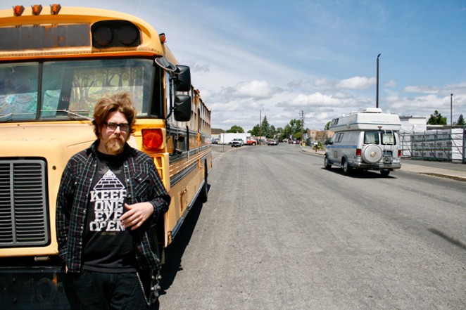Zach Polton stands outside of his school bus, turned home on Northeast First Street in Bend. - CHRIS MILLER