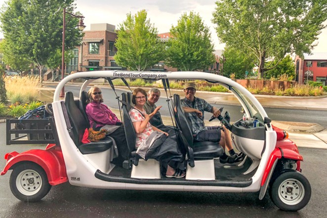 John Flannery and fellow art adventurers in The Bend Tour Company's open-air electric car. - TEAFLY PETERSON