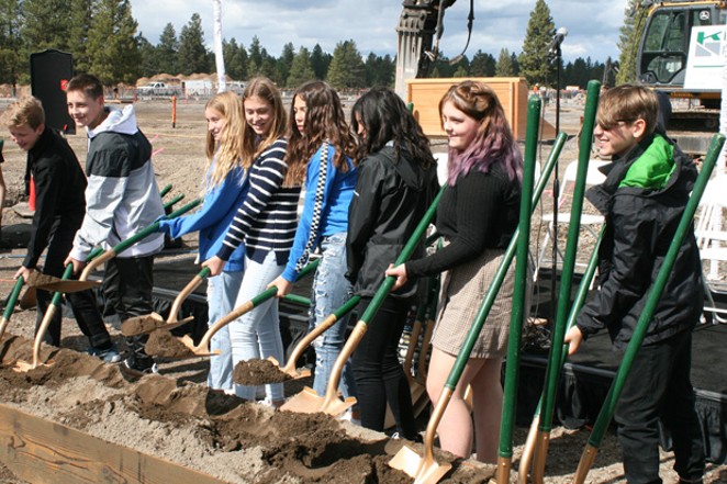 Bend-La Pine Schools students take their turn hoisting the golden shovels at the groundbreaking for the new high school in southeast Bend Sept. 19. - ISAAC BIEHL
