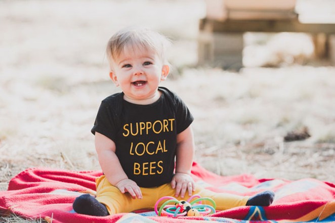 Jimmy Wilkie's daughter, Delilah June, happily supports local bees. - AMANDA PHOTOGRAPHIC