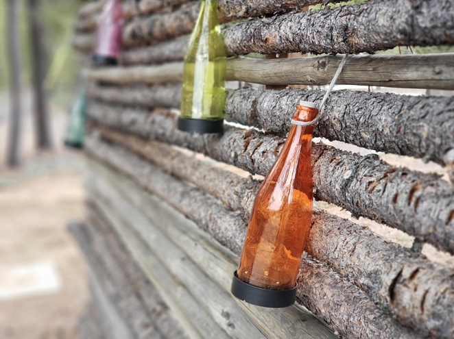 Bottles hanging on a wall! Wow! Artsy! I've been having fun exploring the woods and seeing what strange, photogenic things I fine. - CAYLA CLARK
