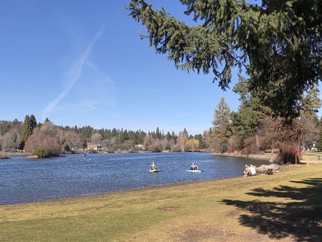 Mirror Pond in Bend's Drake Park Sunday. Bend Park and Recreation District is keeping parks open and requiring 6 feet of social distancing, but closing skate parks, exercise equipment, skate parks and courts. - NICOLE VULCAN