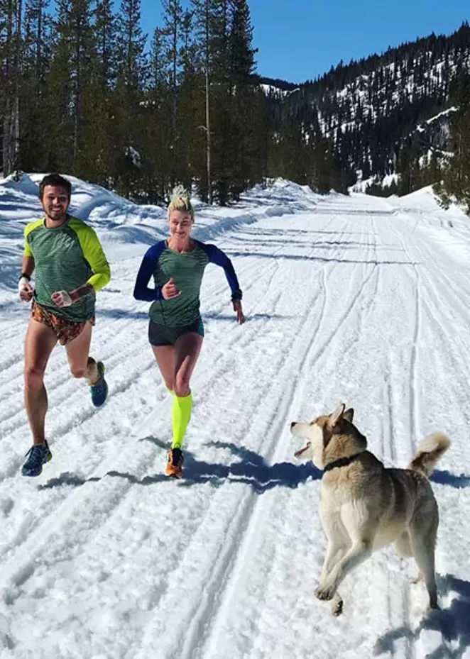 Chris Patterson and Renee Metivier enjoy a snowy run with Raider the Husky. - COURTESY RENEE METIVIER