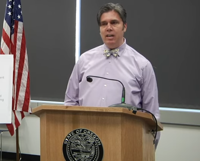 Oregon epidemiologist Dr. Dean Sidelinger talks testing and contact tracing alongside Gov. Brown at today's press conference, wearing his signature bow tie. - SCREENSHOT VIA YOUTUBE - OREGON PUBLIC HEALTH DIVISION CHANNEL