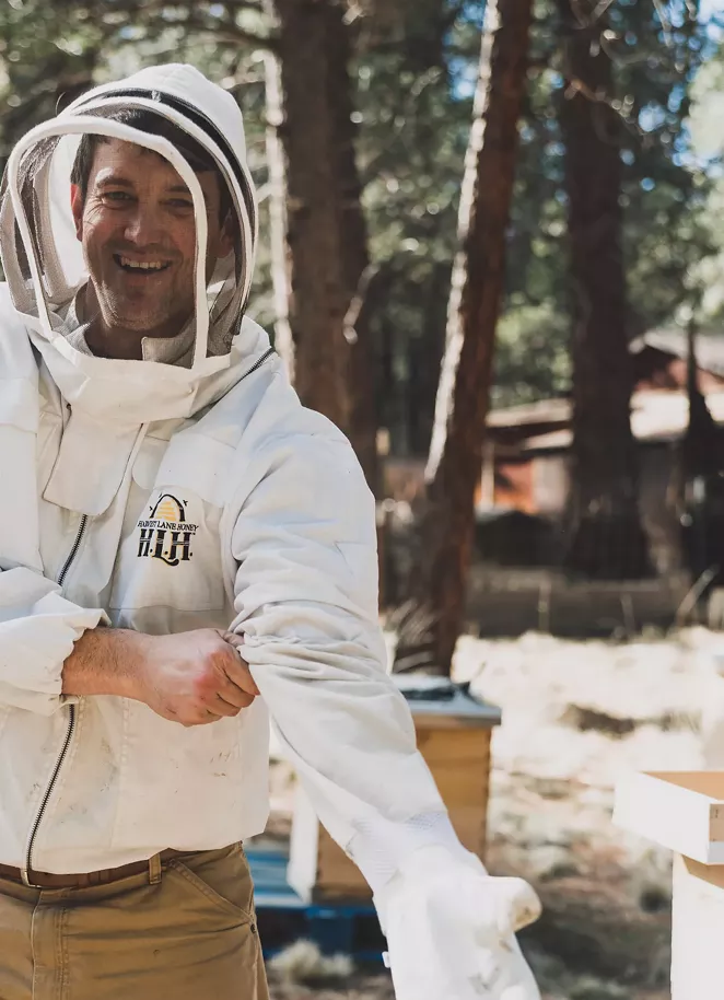 Bend beekeeper Jimmy Wilkie suits up to protect himself while tending to his hives. - AMANDA LONG