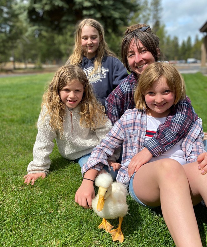 Sara Walker poses with her three, er... four children (including Miss Quackers) in Sunriver. - DYLAN WALKER