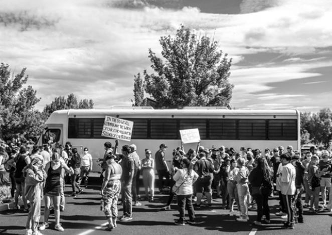 Hundreds gather to prevent U.S. Immigration and Customs Enforcement officers to leave with two Bend residents inside. The buses were parked in the Crane Shed Commons August 12, 2020. - KYLE SWITZER