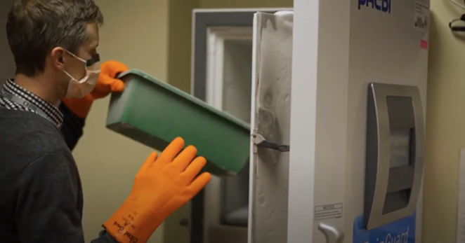 In a screengrab from a video issued by St. Charles, pharmacist Tyler Larson demonstrates the use of the freezer used to store and administer the Pfizer-BioNTech COVID-19 vaccine. - ST. CHARLES HEALTH SYSTEM