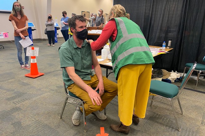 Luke Foster gets the Pfizer-BioNTech vaccine at the Deschutes County Fair &amp; Expo Center on April 2. As of April 5, over 62,000 shots had been administered at that location, county officials said. - HANNA MERZBACH