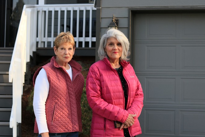 Jan Shamberg and Michelle Knowles stand outside of the garage where they gathered people around the neighborhood to get their signatures notarized to block a Type 2 vacation rental permit. - JACK HARVEL