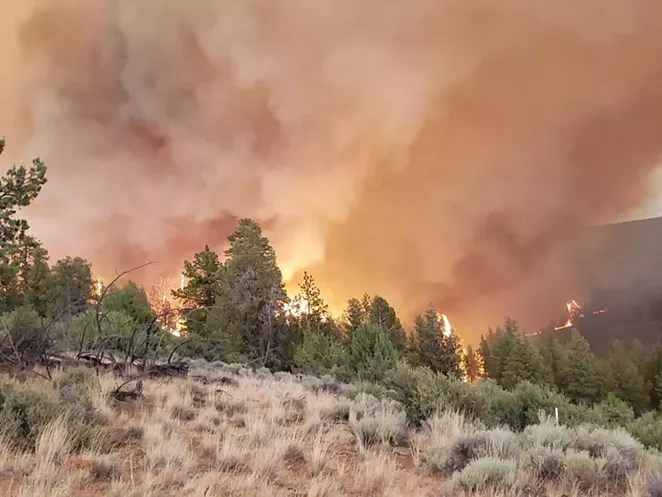 Smoke and flames from the Grandview Fire rise over the horizon on July 11. - INCIWEB