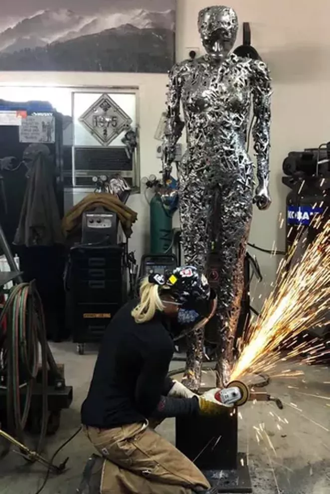 Breezy in the studio grinding on sculpture. - COURTESTY COMAG