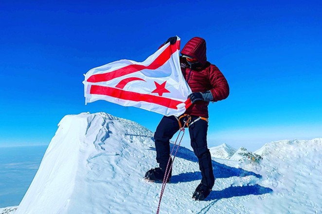Birkan Uzun poses with the Turkish Cypriot flag atop the highest peak of Antarctica. Uzun scaled the highest mountains in five of seven continents during his lifetime. - COURTESY OF BIRKAN UZUN VIA FACEBOOK.