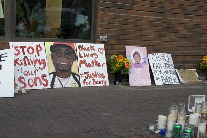 Signs and artwork memorialize Barry Washington at a vigil on Thursday. - JACK HARVEL