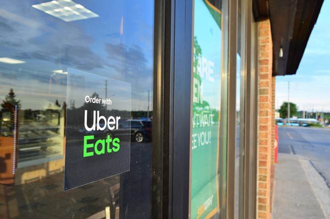 A restaurant advertises its affiliation with Uber Eats. - RAYSONHO VIA WIKIMEDIA