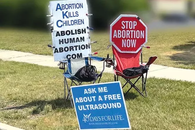 Signs set up by anti-abortion protesters greet patients as they approach the Illinois clinic. - JUDITH DAVIDOFF