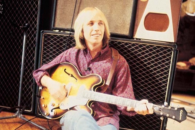 The late Tom Petty, who died Oct. 2, 2017, strums away in a quieter moment. - COURTESY TOMPETTY.COM