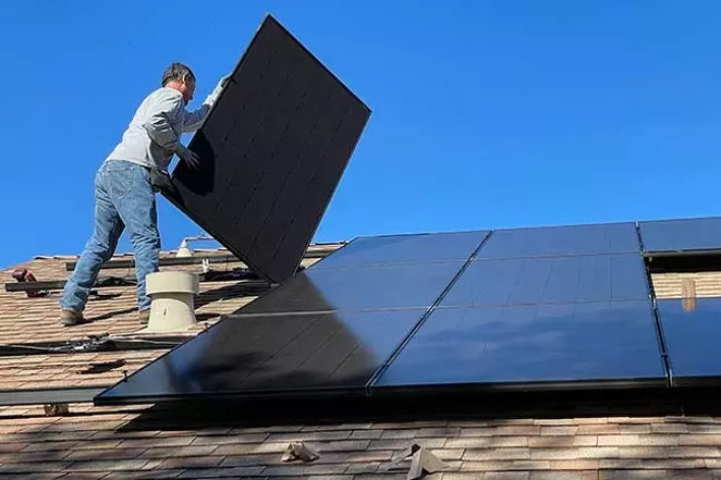 Installing solar panels. - COURTESY OF UNSPLASH