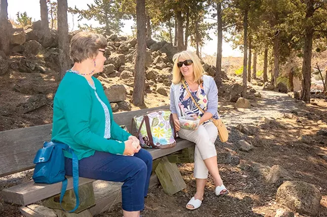 Dawn Mackey, at right, and Tina Fiedler enjoy lunch on a shady Worrell Wayside bench. - SUE ANDERSON