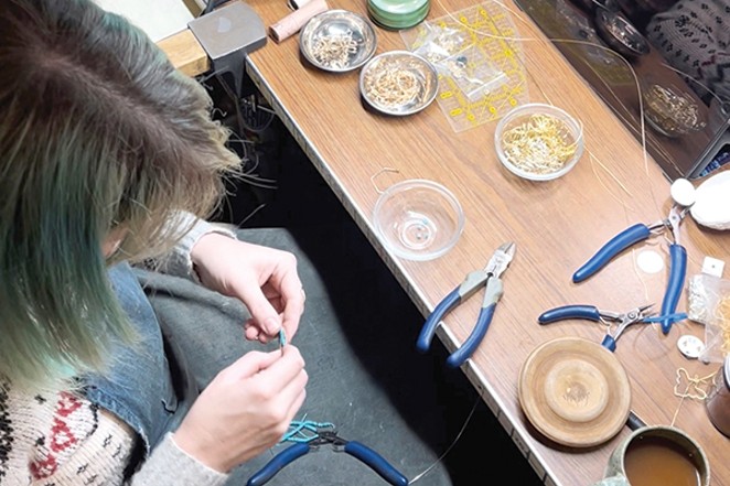 Ashley Scholtes working on some jewelry. - ALLIE NOLAND