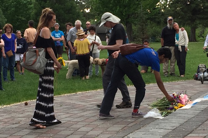 Attendees at the Bend vigil laying flowers - MEAGHAN BULL