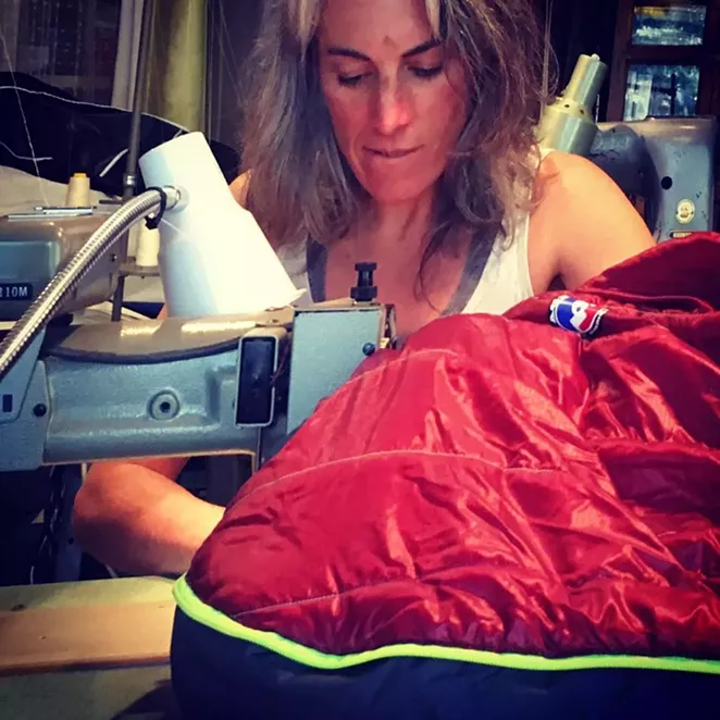 Kinney hard at work at one of her seven industrial sewing machines. - RUGGED THREAD | FACEBOOK