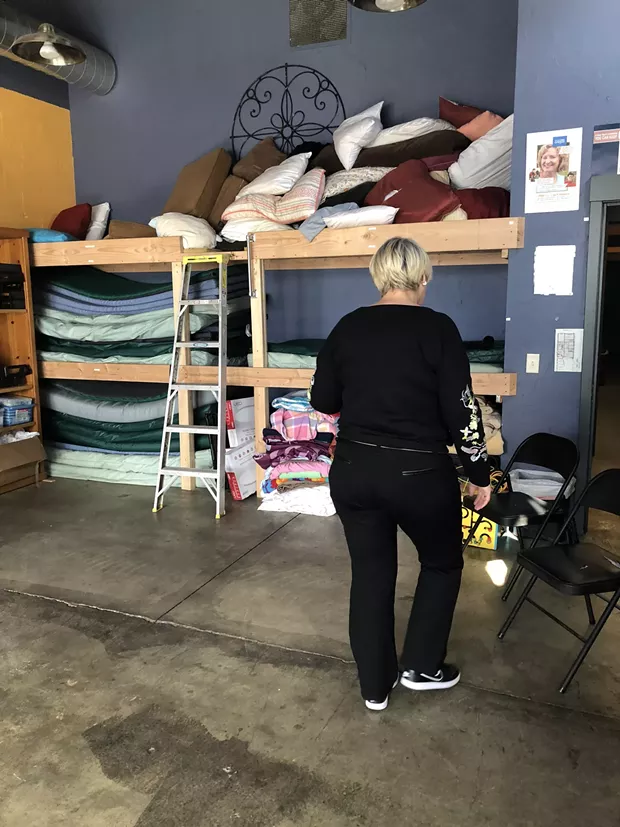 Sally Pfeifer moves chairs around to show off the new bunkbeds in the Sagewood Sanctuary. The room, inside Pfeifer & Associates, is home to group meetings and other support activities during regular business hours. - NICOLE VULCAN