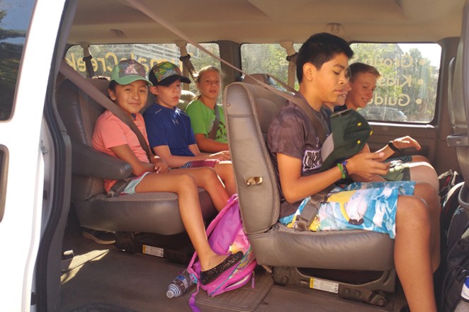 Estrella Aparicio (far left) waits with her paddle classmates to depart for a rafting excursion. - K.M. COLLINS