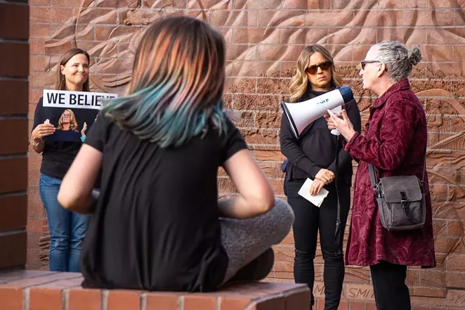 Stacy Sharlet, 60, speaks to a gathering of more than 100 people at the "Believe Survivors Rally" outside of Bend City Hall Wednesday. - KEELY DAMARA