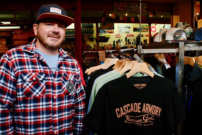Cascade Armory's Alex Short stands next to his clothing line at Skjersaa's in Bend. - CHRIS MILLER