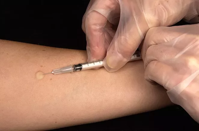 A medical professional gives a vaccination. - PIXABAY