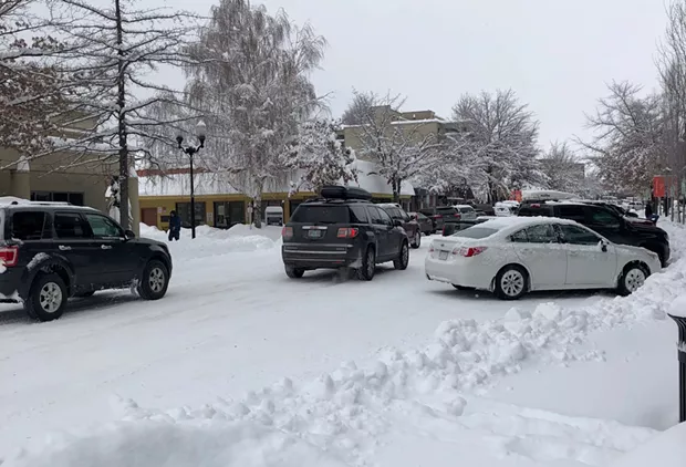 Cars squeeze past each other on Bond Street in downtown Bend Feb. 26. - CHRIS MILLER