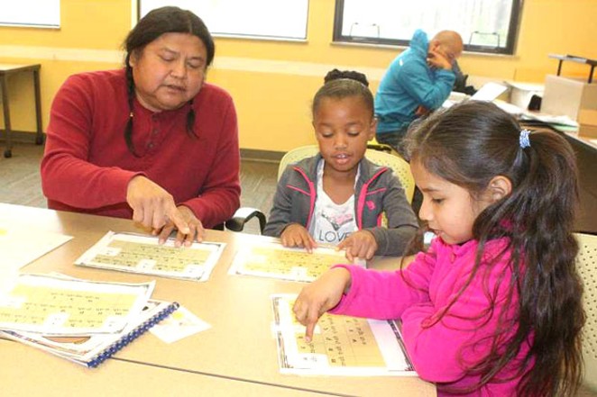Tribal language teacher Dallas Winishut goes over the Ishishkiin (Wasco) alphabet at the Warm Springs K-8 Academy in 2017. The Academy is one of the three schools in the Jefferson County School District has a 21st Century Community Learning Centers afterschool program. - MADRAS PIONEER