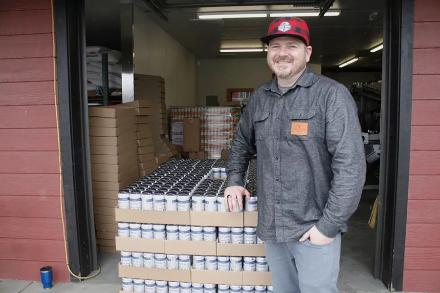 Cascade Armory's Alex Short standing next to a pallet of Blunder Armour. - CHRIS MILLER