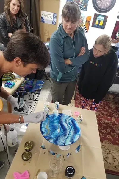 Artist Erica Turpijn discusses Epoxy Resin Art with Patty Garner and Wendy Jacobs at the DCAA monthly meeting. - CARI BROWN