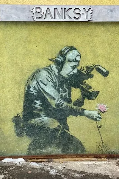 The best known Banksy art in Park City, “Camera Man and Flower,” is located in an alley right off Main Street downtown. It appeared during the 2010 festival, coinciding with the street art documentary, “Exit Through the Gift Shop,” directed by the underground graffiti artist. It has been framed and covered with bullet-proof glass for protection. - COURTESY FLOY SITTS