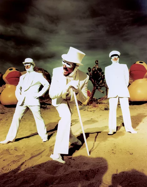 The members of Primus, in white-suit glory. - CHAPMAN BAEHLER