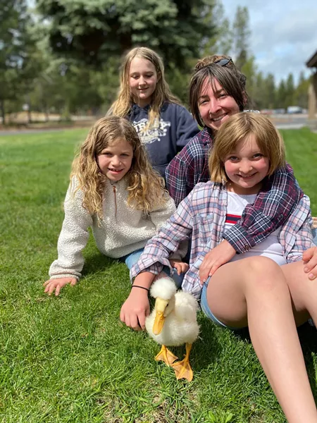 Sara Walker poses with her three, er... four children (including Miss Quackers) in Sunriver. - DYLAN WALKER