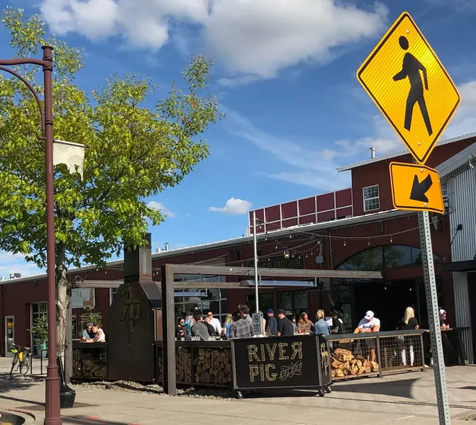 Patrons gather on the River Pig Saloon patio on a beautiful Sunday afternoon. - CAYLA CLARK