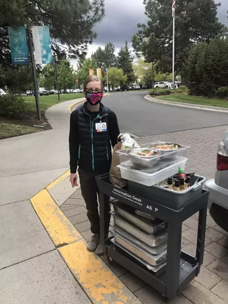 An employee at St. Charles waits to bring in the goods from the St. Charles Meal Mission. - COURTESY ERIC LEADBETTER