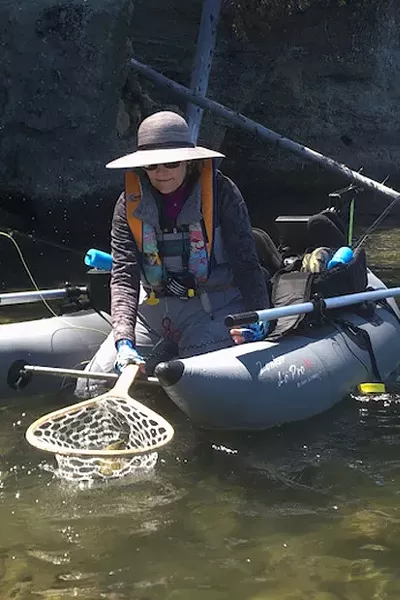 Susan Coyle successfully catches a large rainbow trout at East Lake. - COURTESY SUSAN COYLE