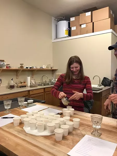 To develop a new chai concentrate Amy Lee Stahl blind tasted lots of different chais. Here she is pouring chai into a blank cup. The name of the producer was listed on the bottom. - METOLIUS TEAS