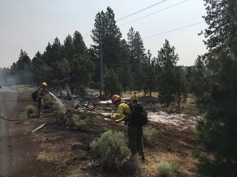 USFS crews mopping up small fire on Century Drive. - DAN DERLACKI.