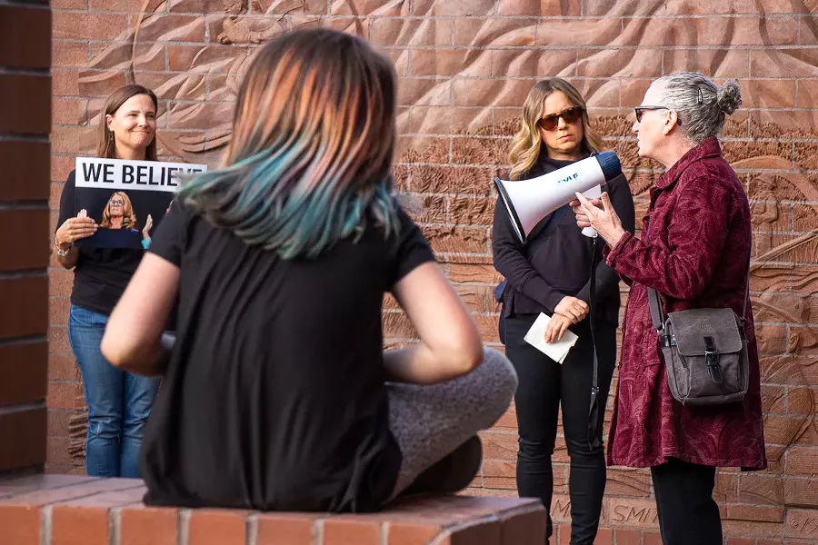 Stacy Sharlet, 60, speaks to a gathering of more than 100 people at the "Believe Survivors Rally" outside of Bend City Hall Wednesday. - KEELY DAMARA