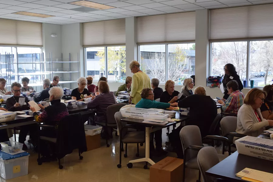 Dozens of volunteers work counting ballots on Election Day. - JACLYN BRANDT
