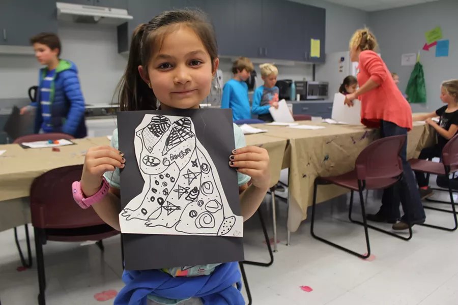 A student displays her artwork from an enrichment activity with Kids Inc. at Juniper Elementary. - BEND PARK AND RECREATION DISTRICT
