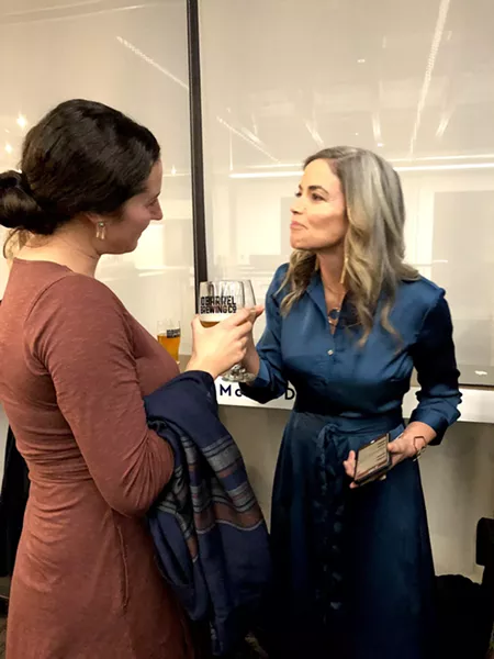 Gena Goodman-Campbell and Amy Lowes mingle at a Democratic election party Tuesday night. - CHRIS MILLER