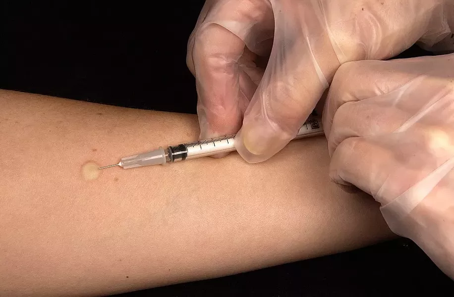 A medical professional gives a vaccination. - PIXABAY