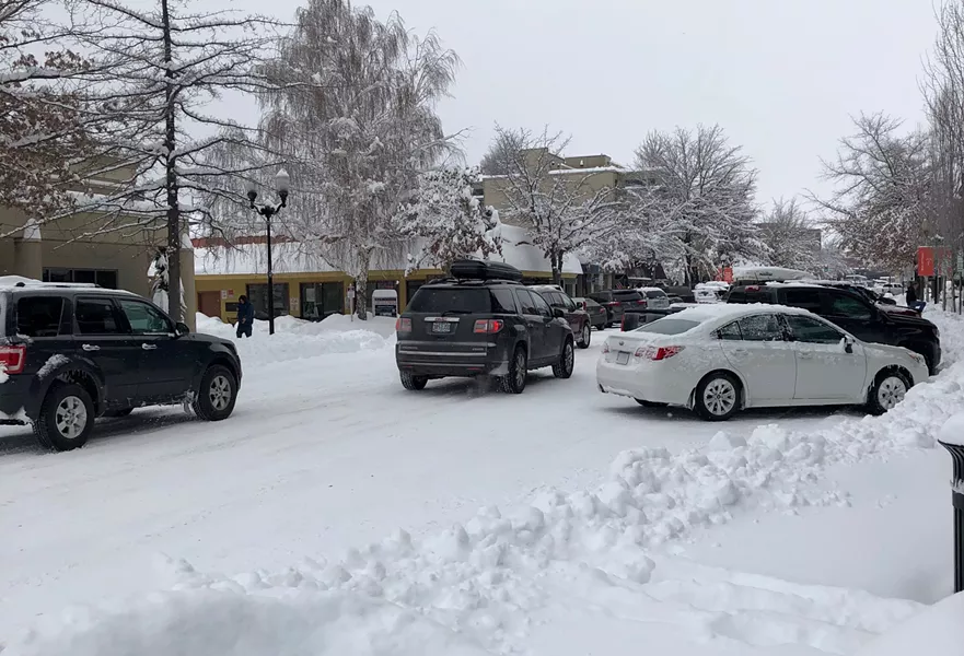 Cars squeeze past each other on Bond Street in downtown Bend Feb. 26. - CHRIS MILLER
